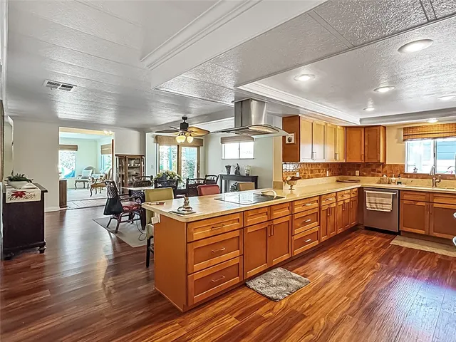 a large kitchen with lots of counter and chairs