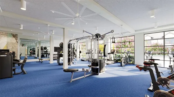 a living room with furniture gym equipment and a large window