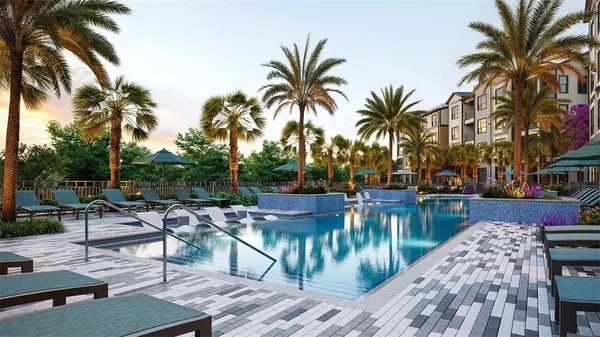 a view of a swimming pool with lounge chairs on a patio