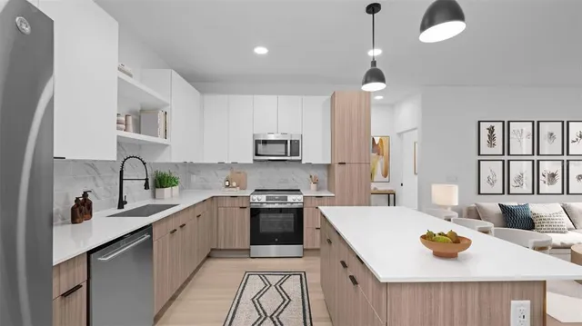 a kitchen with a stove a sink and a refrigerator