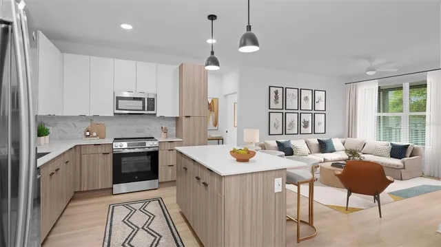 a kitchen with sink a stove and chairs