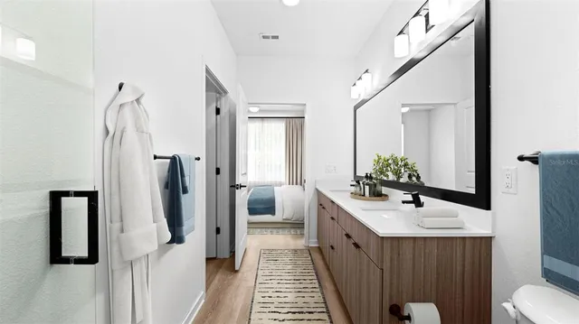 a bathroom with a double vanity sink and a mirror