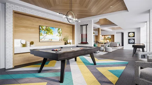 a view of a dining room with furniture a rug and wooden floor