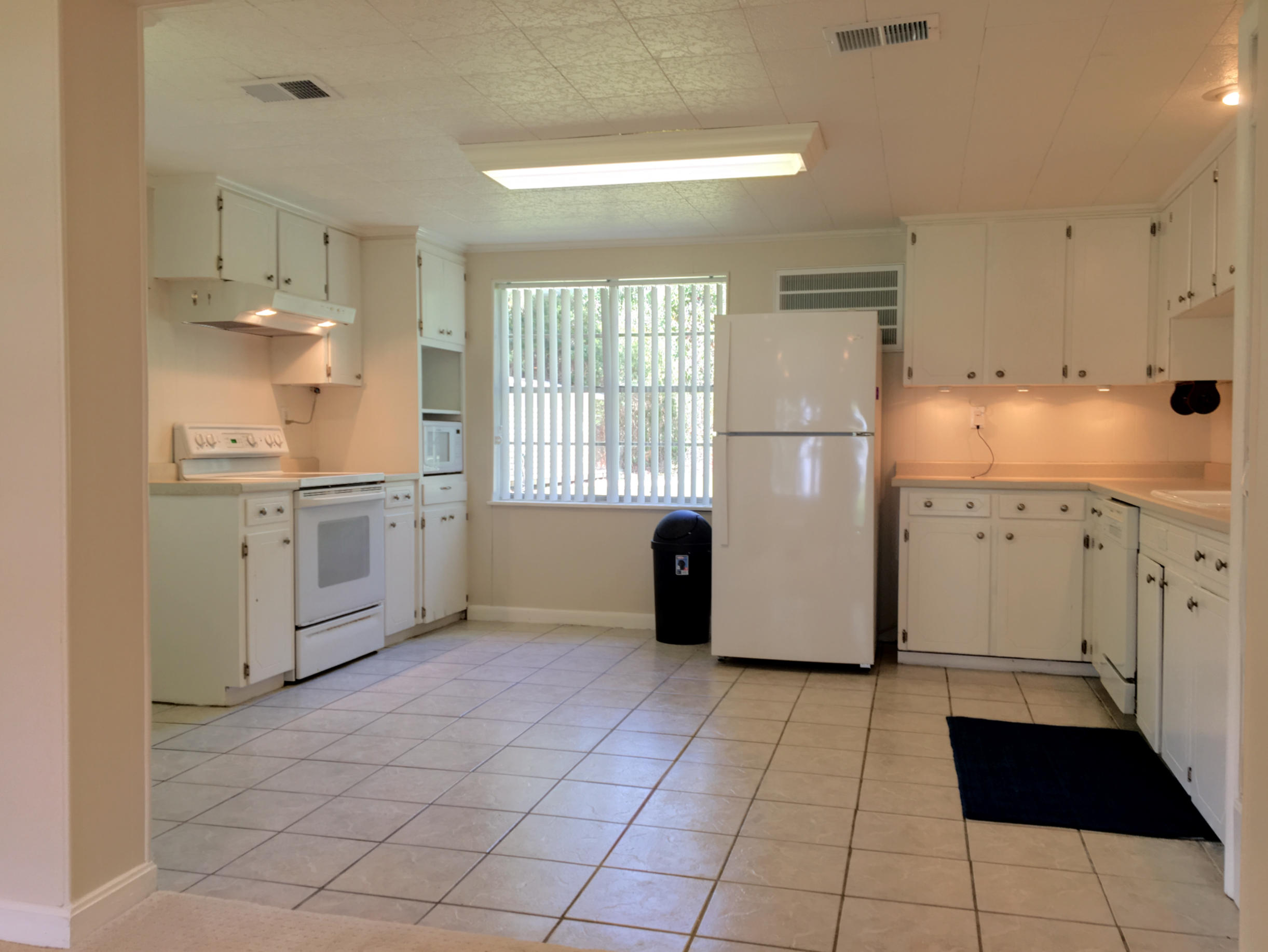 2461 Bay Grove Road Freeport, FL 32439 - Photo 3 of 44 a kitchen with a refrigerator a sink and cabinets