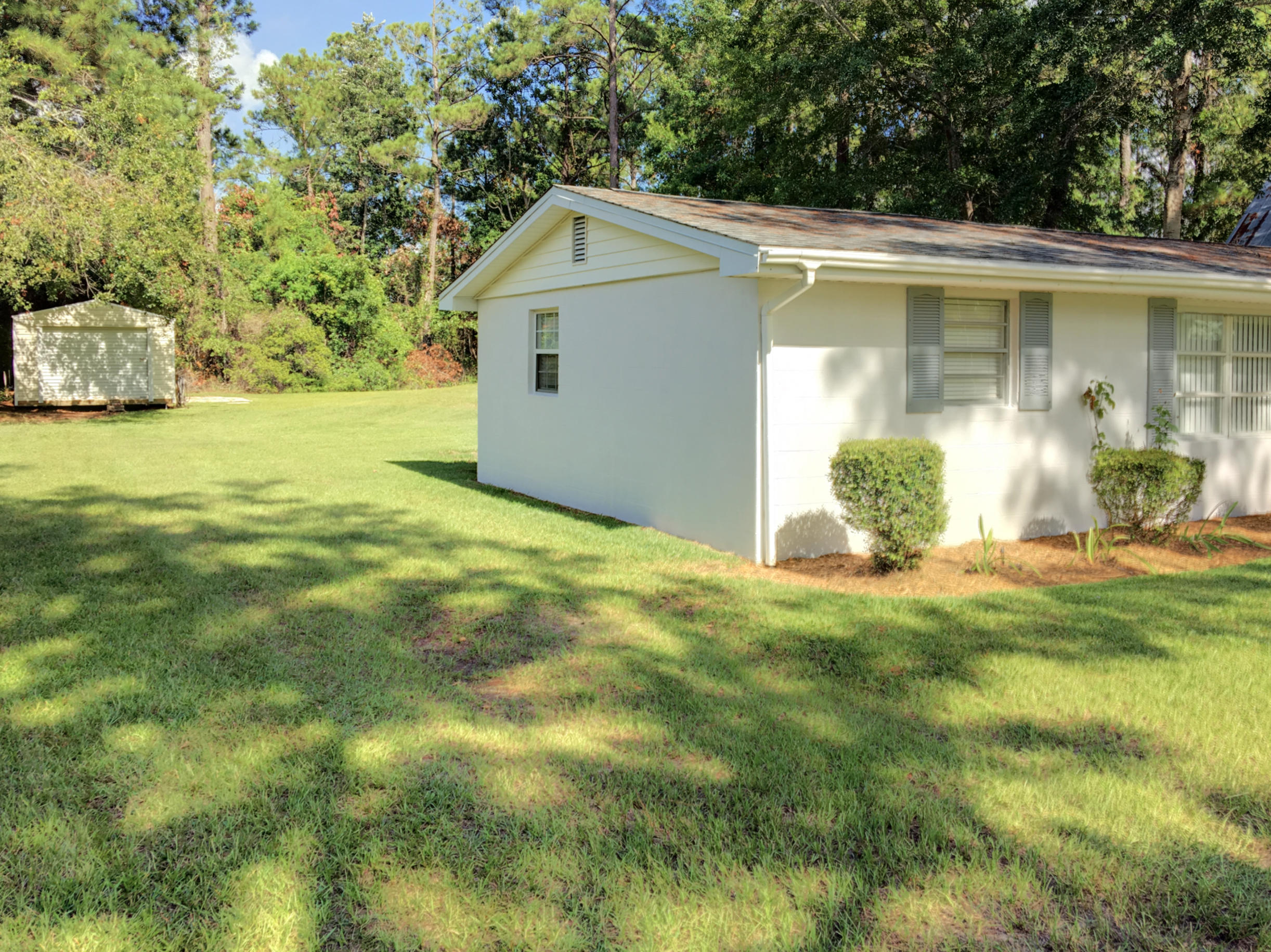 2461 Bay Grove Road Freeport, FL 32439 - Photo 40 of 44 a front view of a house with garden