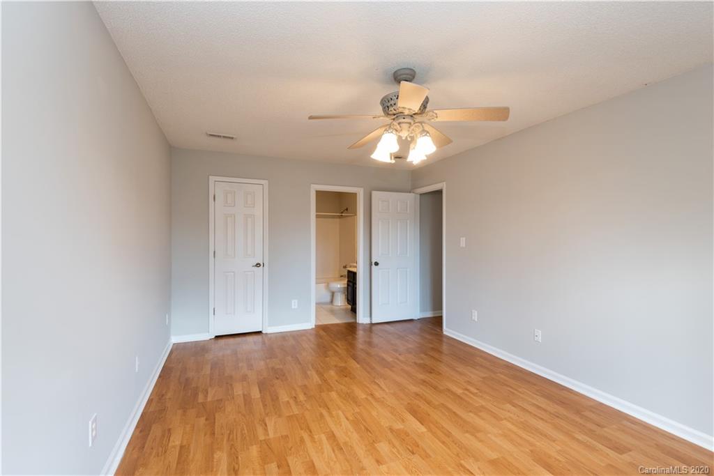 10602 Fairway Ridge Road Charlotte, NC 28277 - Photo 15 of 32 a view of a big room with wooden floor and chandelier fan