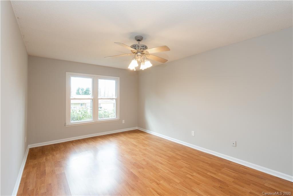 10602 Fairway Ridge Road Charlotte, NC 28277 - Photo 16 of 32 an empty room with wooden floor and windows