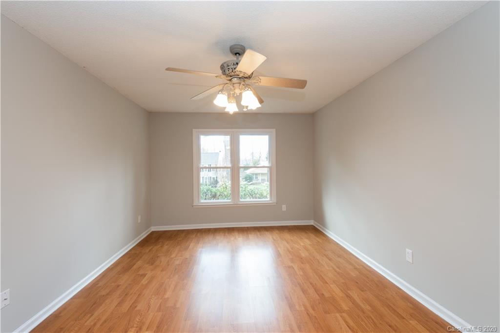 10602 Fairway Ridge Road Charlotte, NC 28277 - Photo 17 of 32 an empty room with wooden floor fan and windows