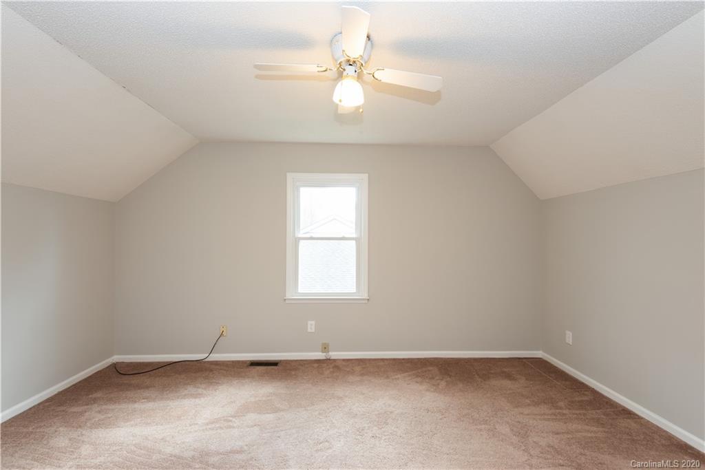 10602 Fairway Ridge Road Charlotte, NC 28277 - Photo 22 of 32 an empty room with a window and a ceiling fan