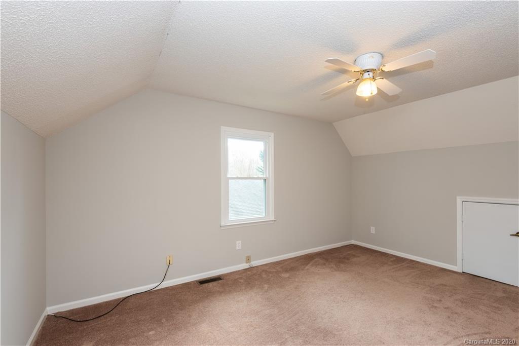 10602 Fairway Ridge Road Charlotte, NC 28277 - Photo 23 of 32 an empty room with a window and a fan