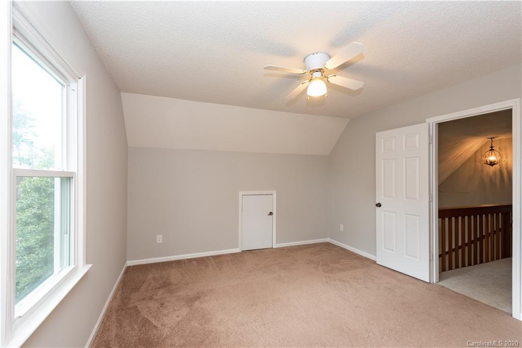 10602 Fairway Ridge Road Charlotte, NC 28277 - Photo 24 of 32 a view of an empty room with window and chandelier fan
