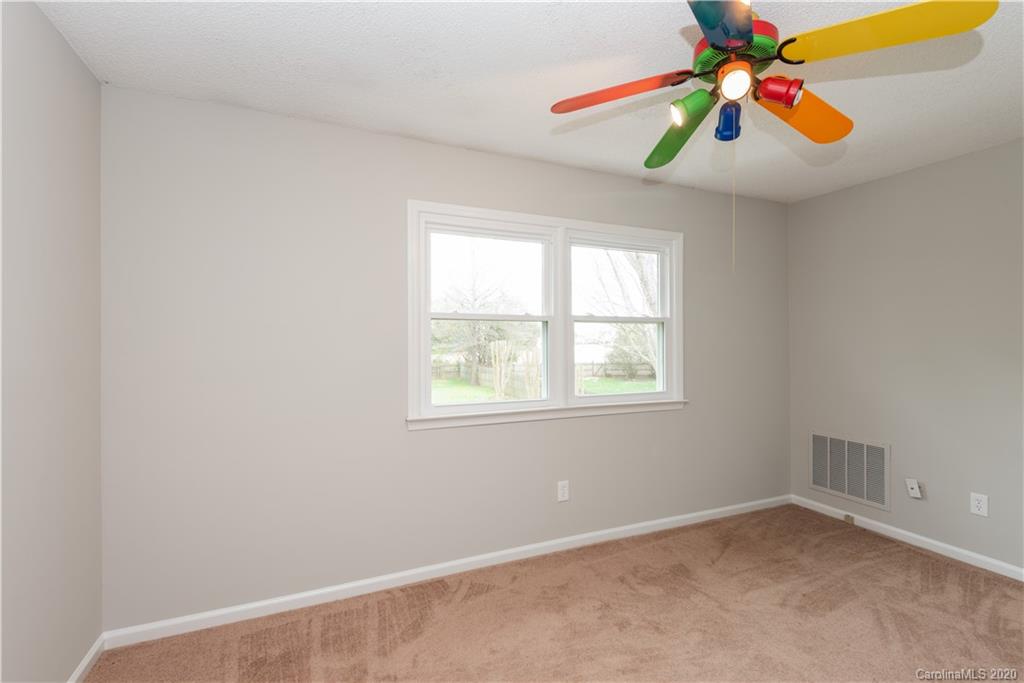 10602 Fairway Ridge Road Charlotte, NC 28277 - Photo 26 of 32 an empty room with ceiling fan and window