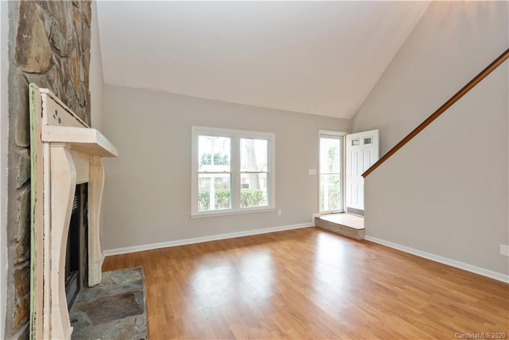 10602 Fairway Ridge Road Charlotte, NC 28277 - Photo 5 of 32 a view of an empty room with wooden floor and a window
