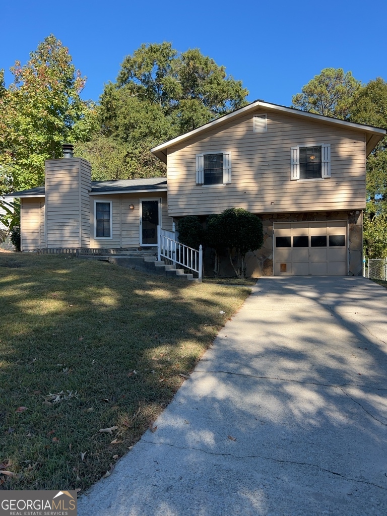 a view of house with yard