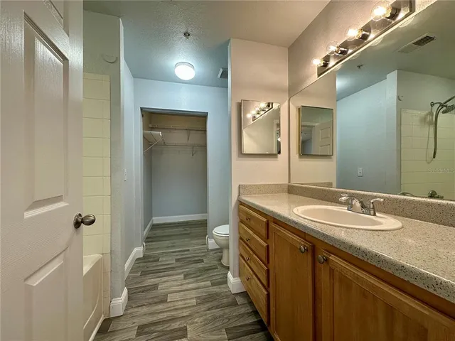 a bathroom with a tub sink and mirror