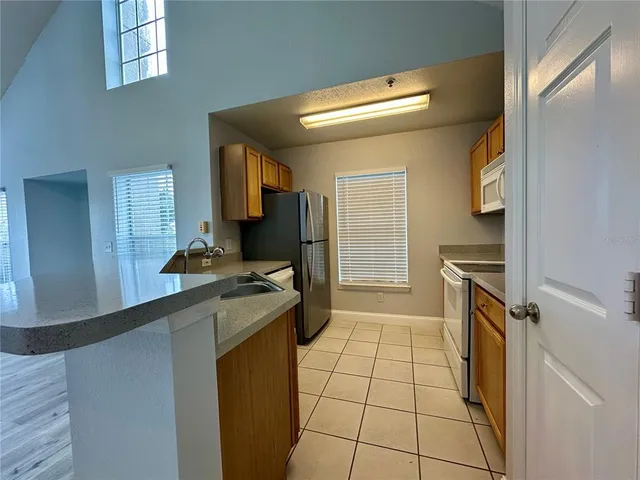 a kitchen with a sink a stove top oven and cabinets