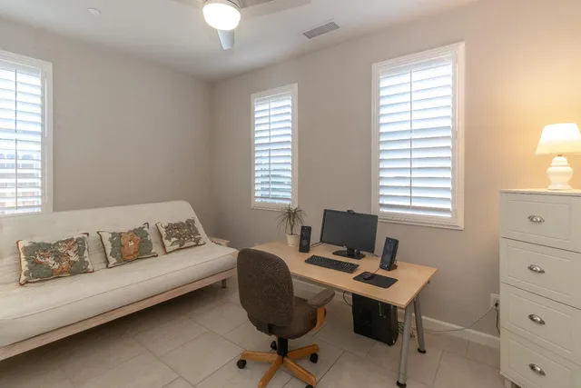 a view of a workspace with a window and lounge chair