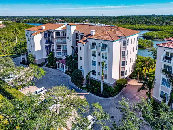 an aerial view of multiple houses with a yard
