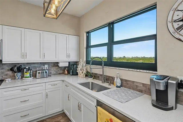 a kitchen with stainless steel appliances a sink a stove and cabinets