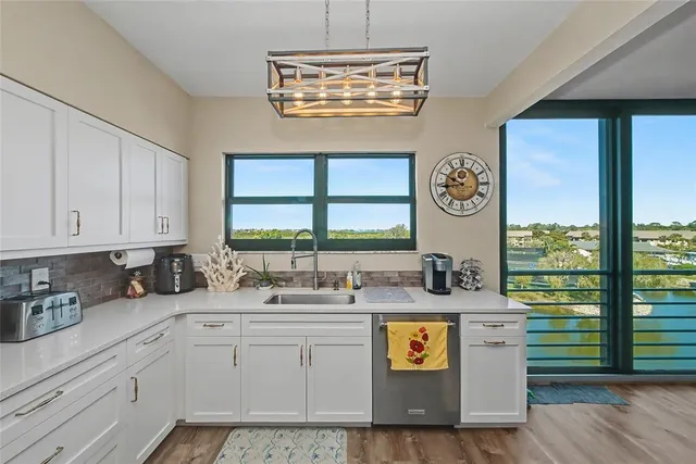 a kitchen with white cabinets stainless steel appliances and a counter space