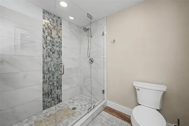 a bathroom with a toilet a sink and shower