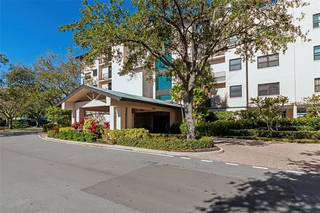 a front view of a house with a yard and a garage