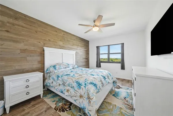 a bedroom with a bed and a chandelier