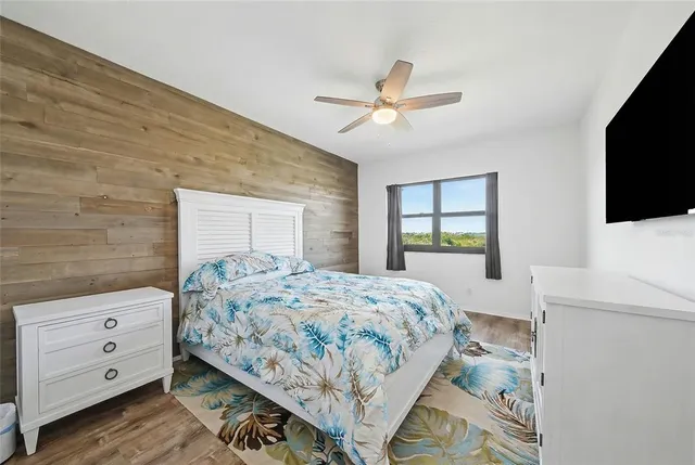 a bedroom with a bed and a chandelier