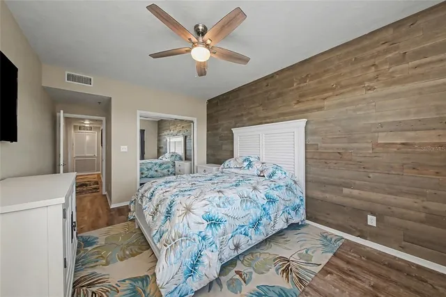 a bathroom with a granite countertop toilet sink and mirror