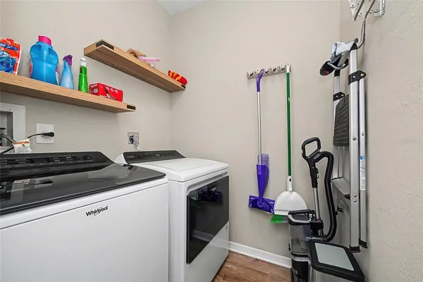 a kitchen with kitchen island granite countertop a sink appliances cabinets and a large window