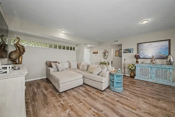 a living room with furniture and a wooden floor