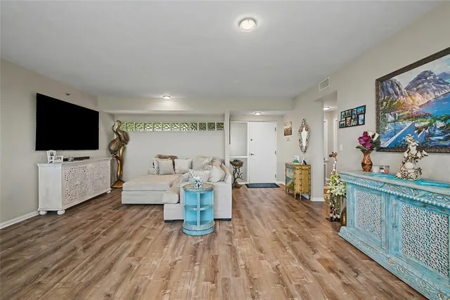 a view of a livingroom with furniture and a flat screen tv