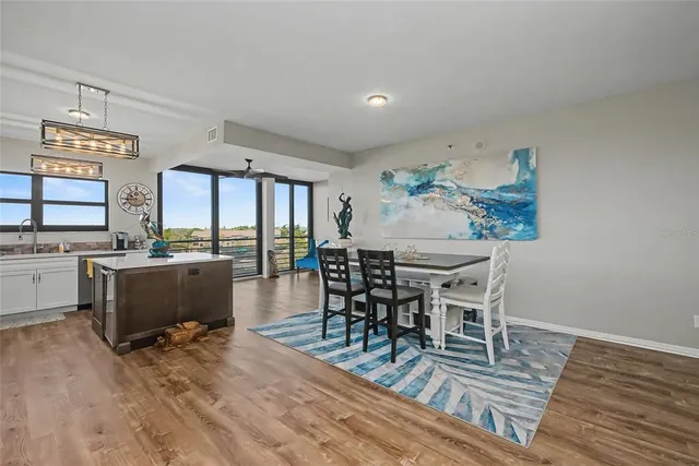 a dining room with furniture and wooden floor