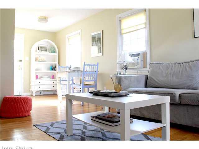 49 Robin Road, Unit 49 West Hartford, CT 06119 - Photo 1 of 1 a living room with furniture and a wooden floor
