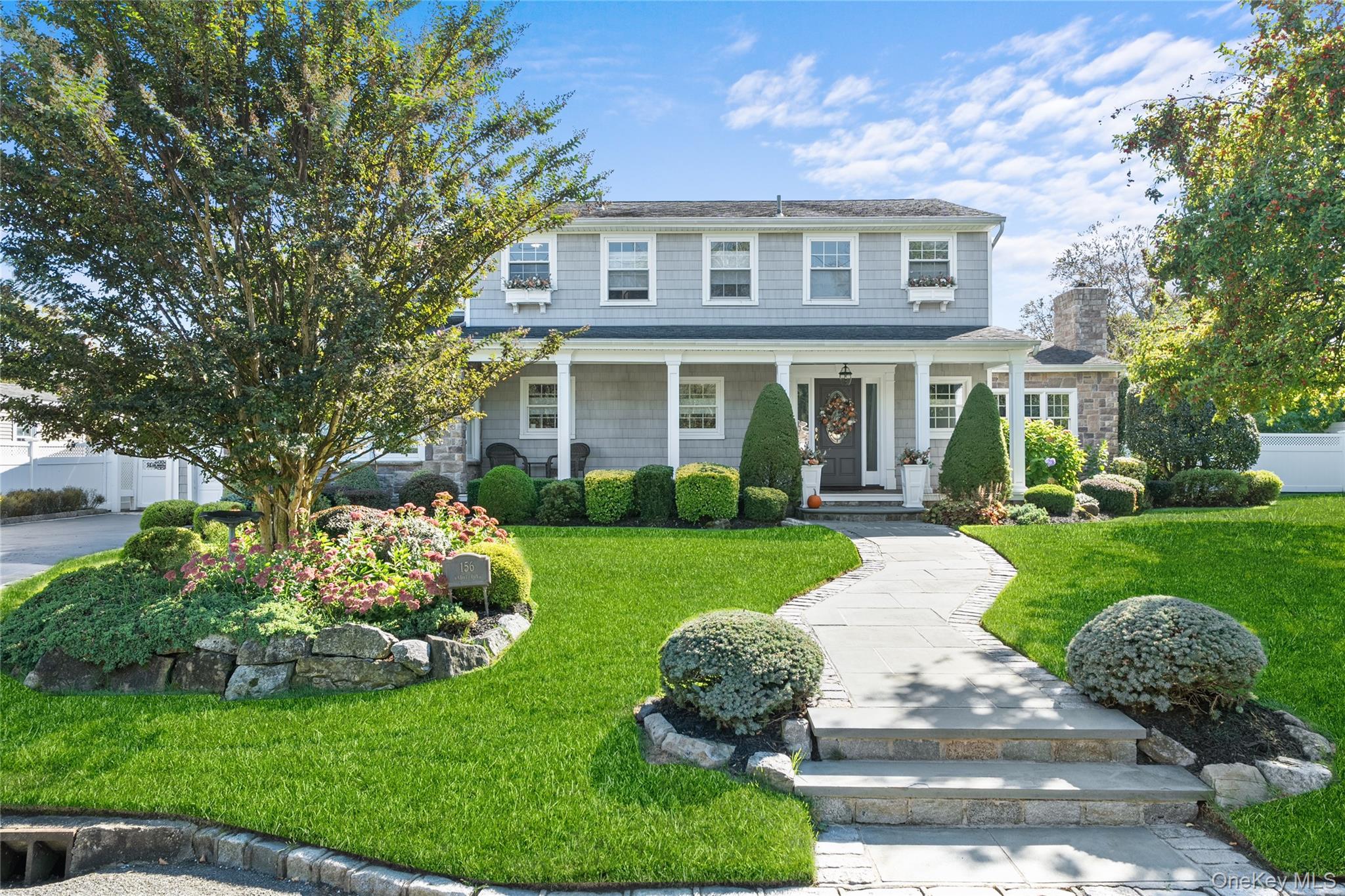 156 Cabot Road Massapequa, NY 11758 - Photo 1 of 1 a front view of a house with a yard table and chairs