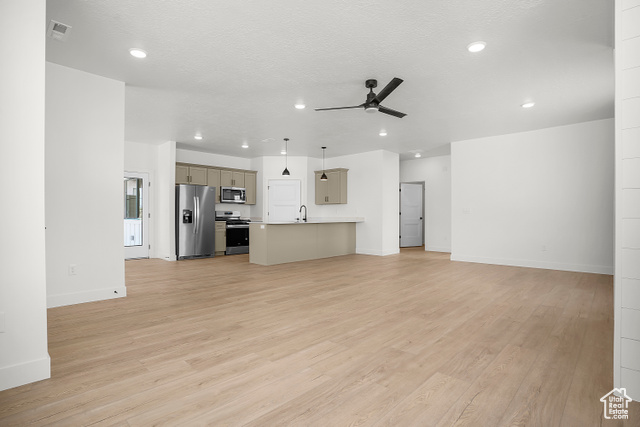 1631 West Century Lane, Unit B Mapleton, UT 84664 - Photo 7 of 33 Unfurnished living room with light wood-style flooring, recessed lighting, a ceiling fan, and a textured ceiling