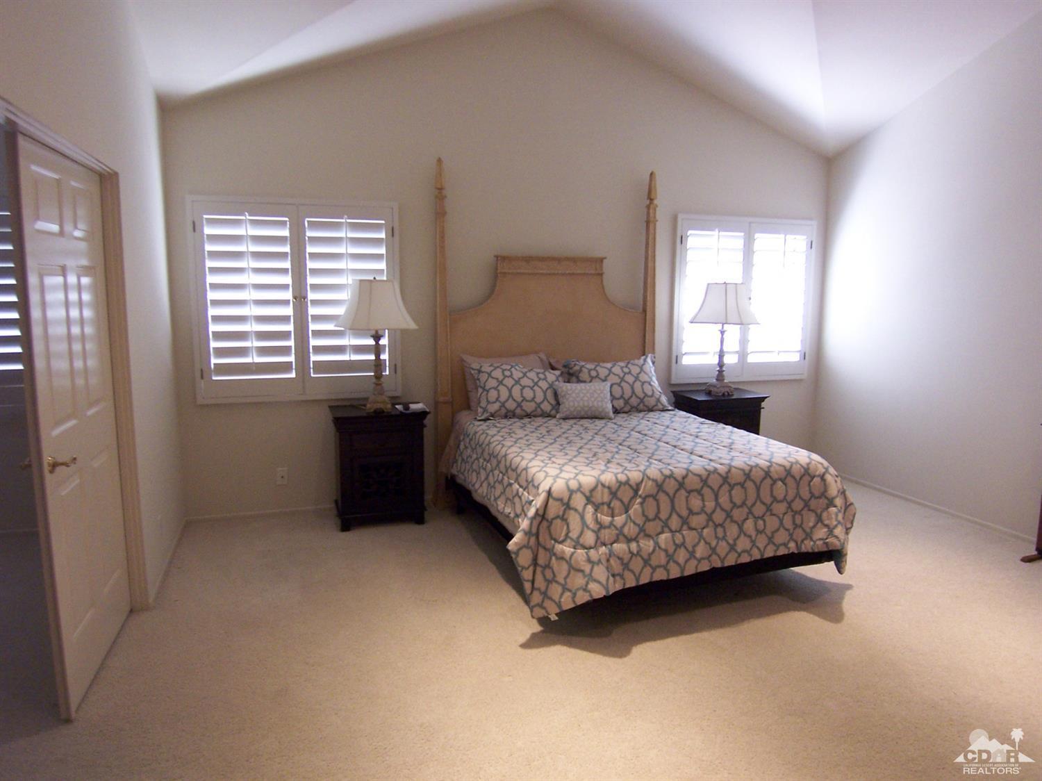 195 Desert Lakes Drive Rancho Mirage, CA 92270 - Photo 14 of 28 a bedroom with a bed and a window