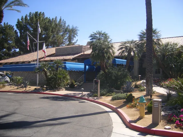 a view of a patio with swimming pool and sitting area