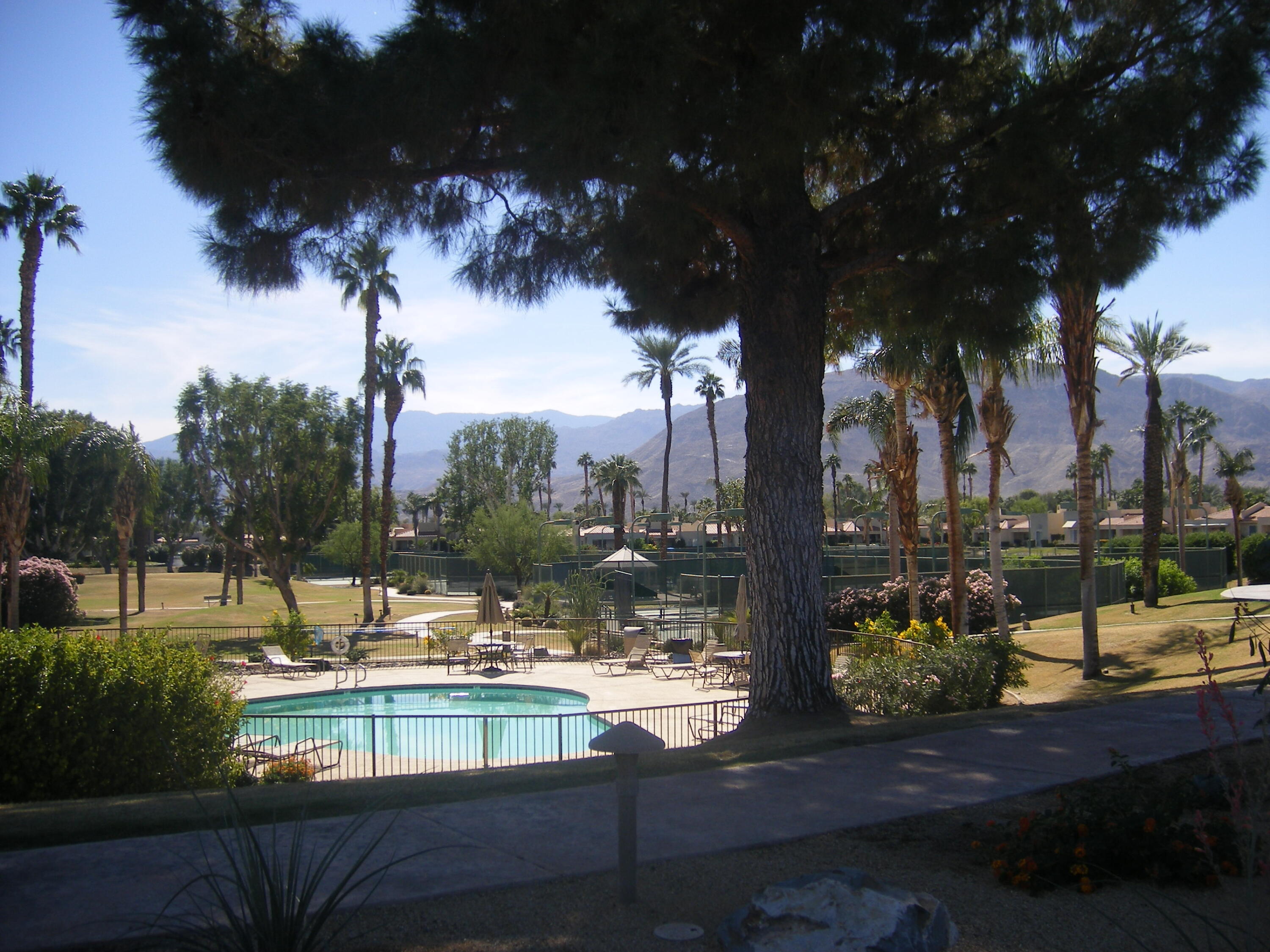 195 Desert Lakes Drive Rancho Mirage, CA 92270 - Photo 27 of 28 a view of a lake with a house and a yard with swimming pool