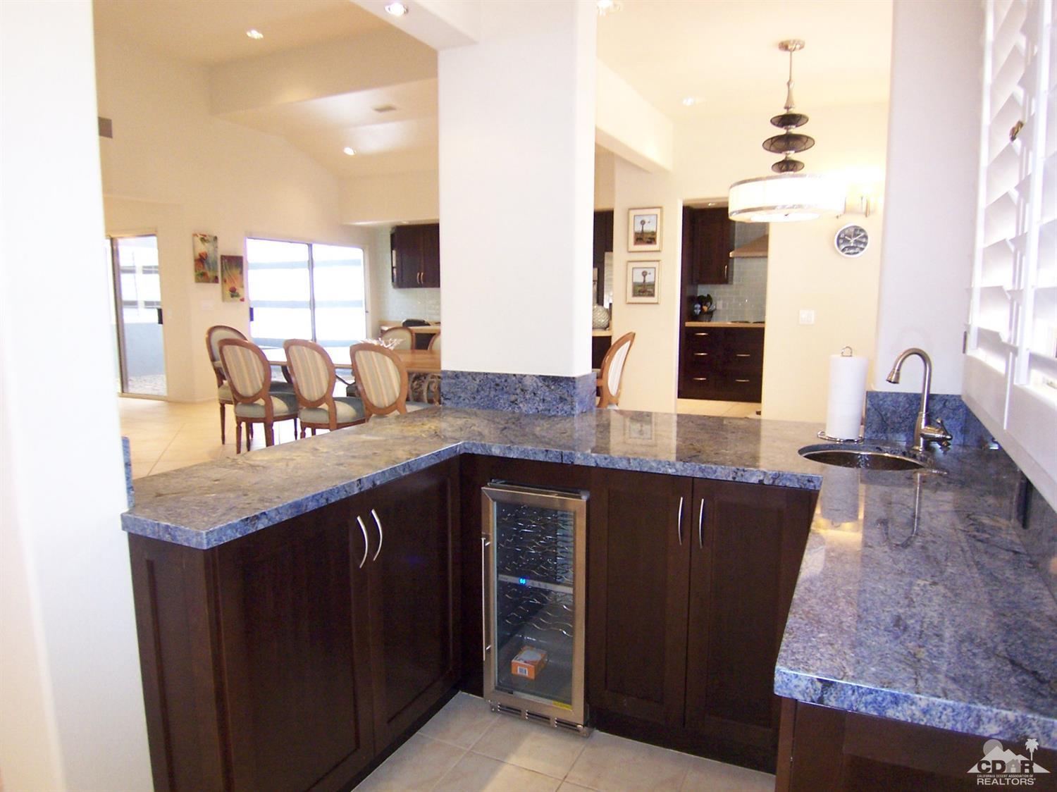 195 Desert Lakes Drive Rancho Mirage, CA 92270 - Photo 8 of 28 a kitchen with granite countertop a sink and cabinets