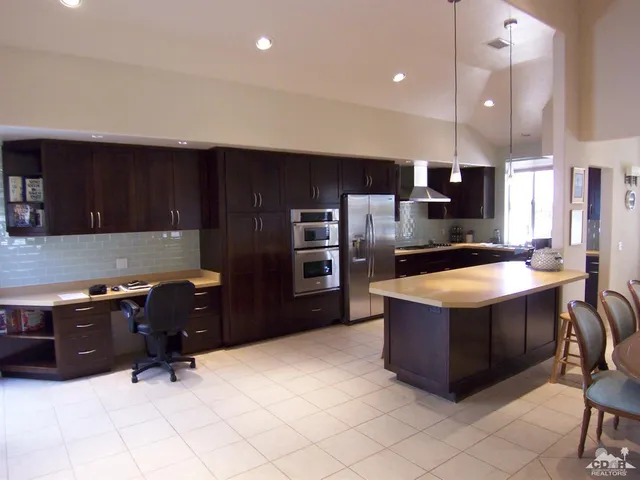 a kitchen with stainless steel appliances wooden cabinets and granite counter tops