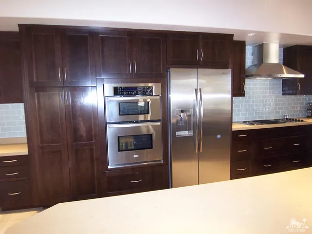 a kitchen with a refrigerator and a sink