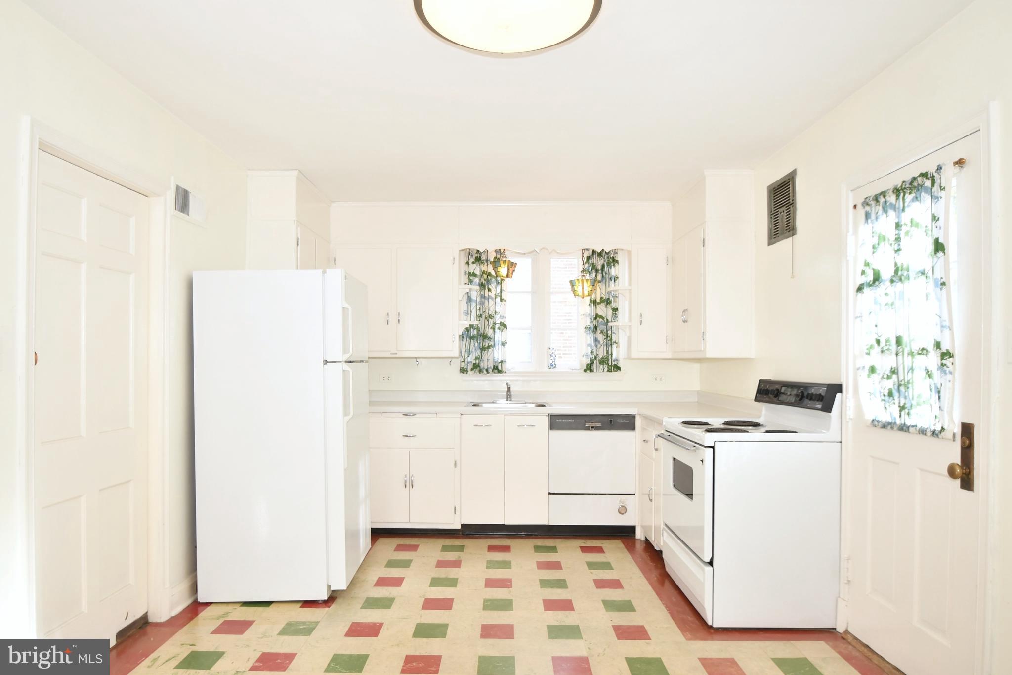 7009 Mornington Road Dundalk, MD 21222 - Photo 11 of 48 a kitchen with a stove a sink and a refrigerator