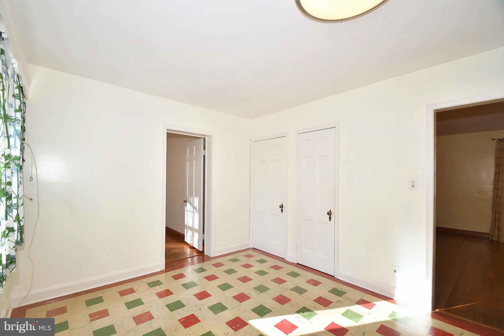 7009 Mornington Road Dundalk, MD 21222 - Photo 12 of 48 a bedroom with a bed and a lamp