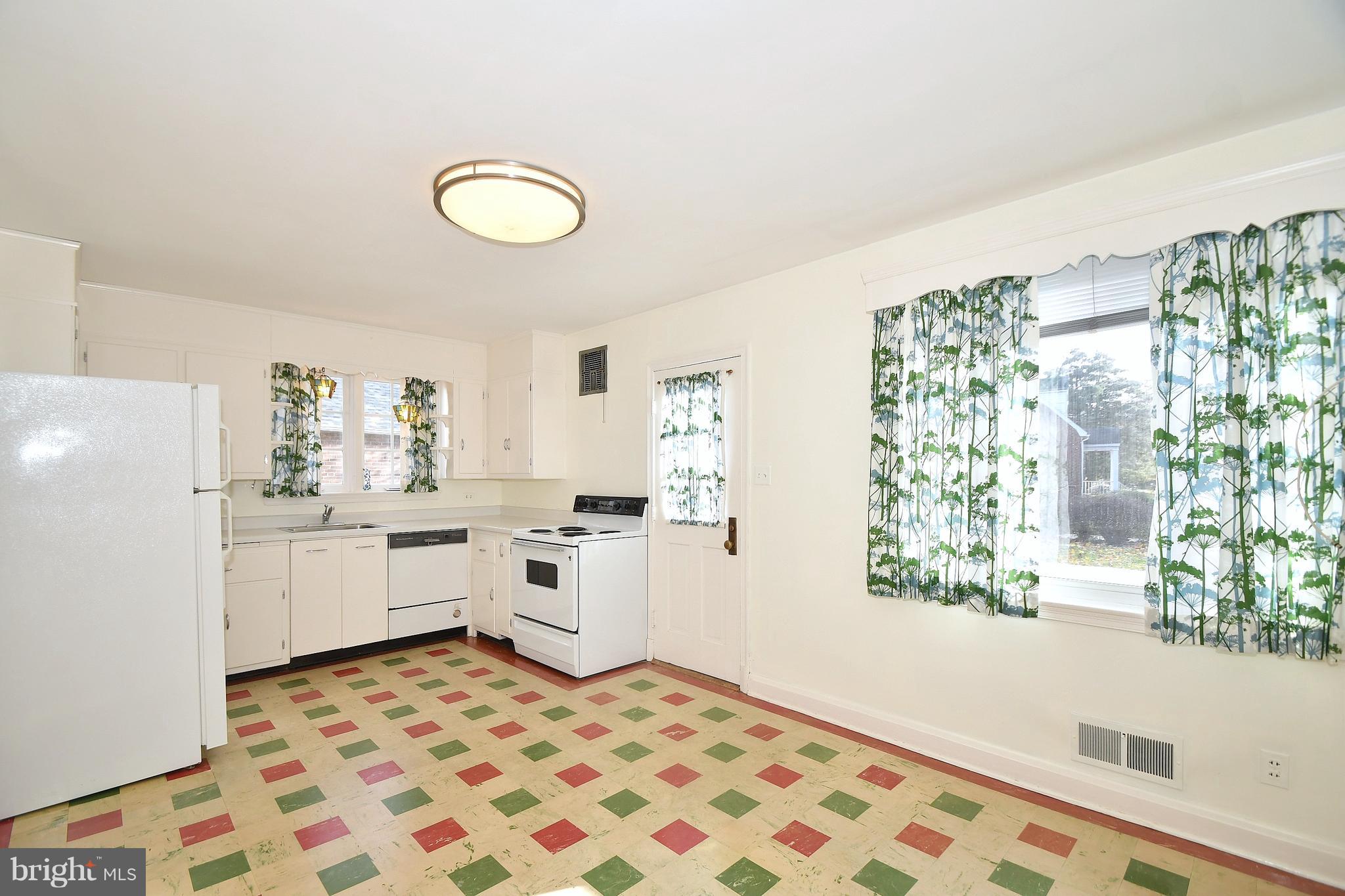 7009 Mornington Road Dundalk, MD 21222 - Photo 13 of 48 a room with kitchen island a stove a sink and a window
