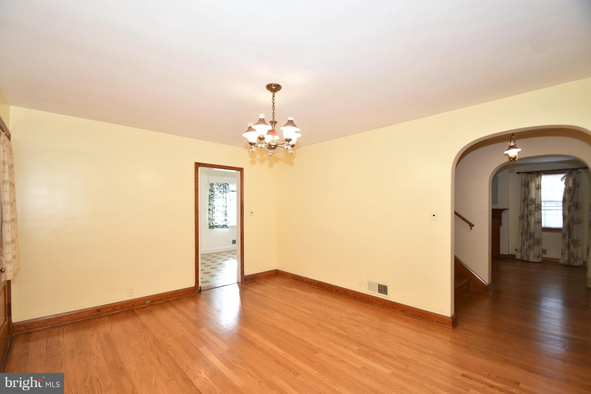 7009 Mornington Road Dundalk, MD 21222 - Photo 14 of 48 a view of a room with wooden floor and chandelier