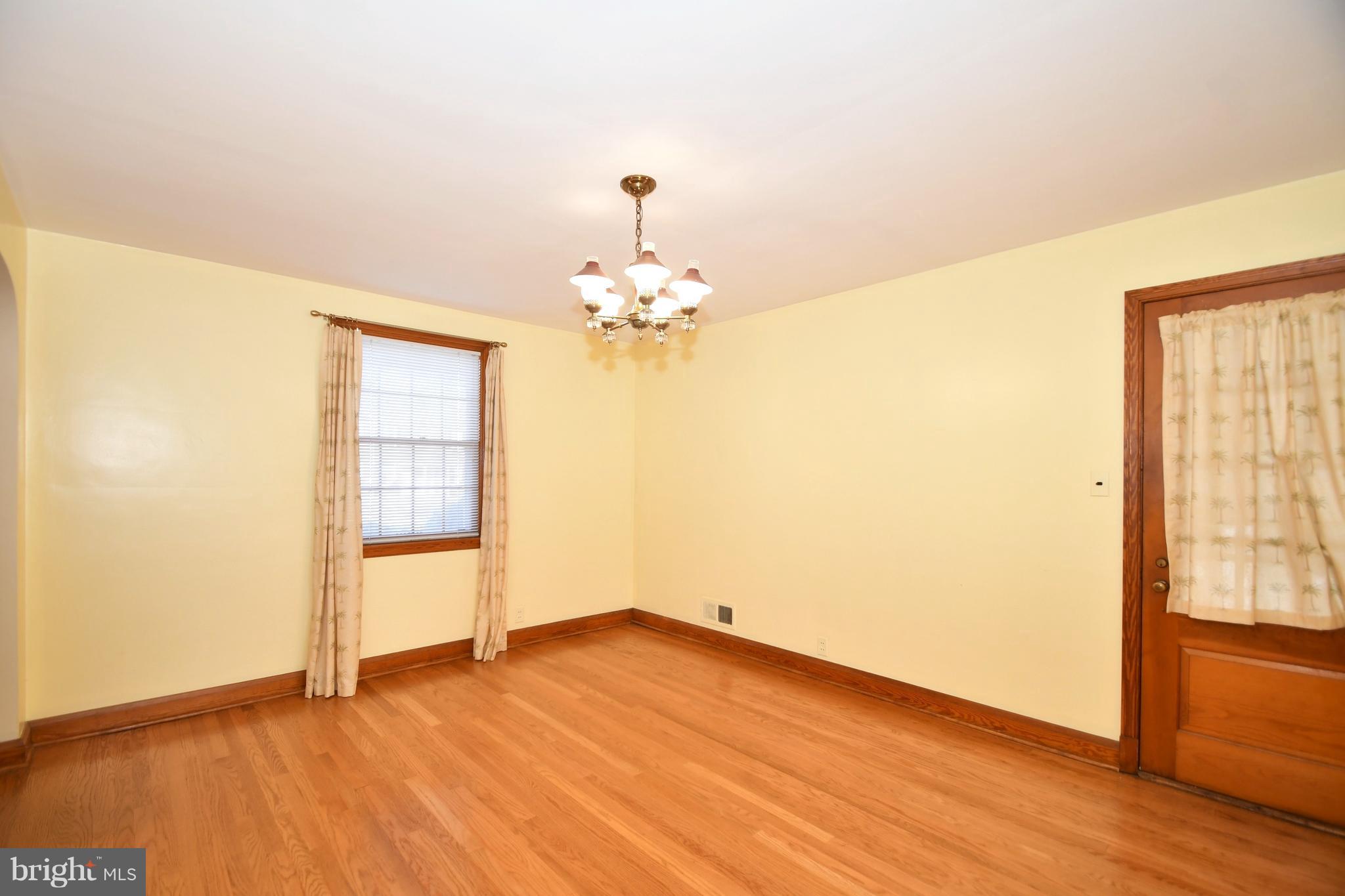 7009 Mornington Road Dundalk, MD 21222 - Photo 15 of 48 wooden floor in an empty room with a window