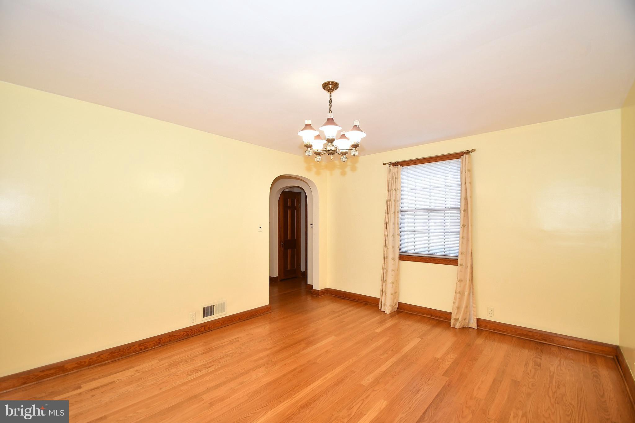7009 Mornington Road Dundalk, MD 21222 - Photo 17 of 48 wooden floor in an empty room with a window