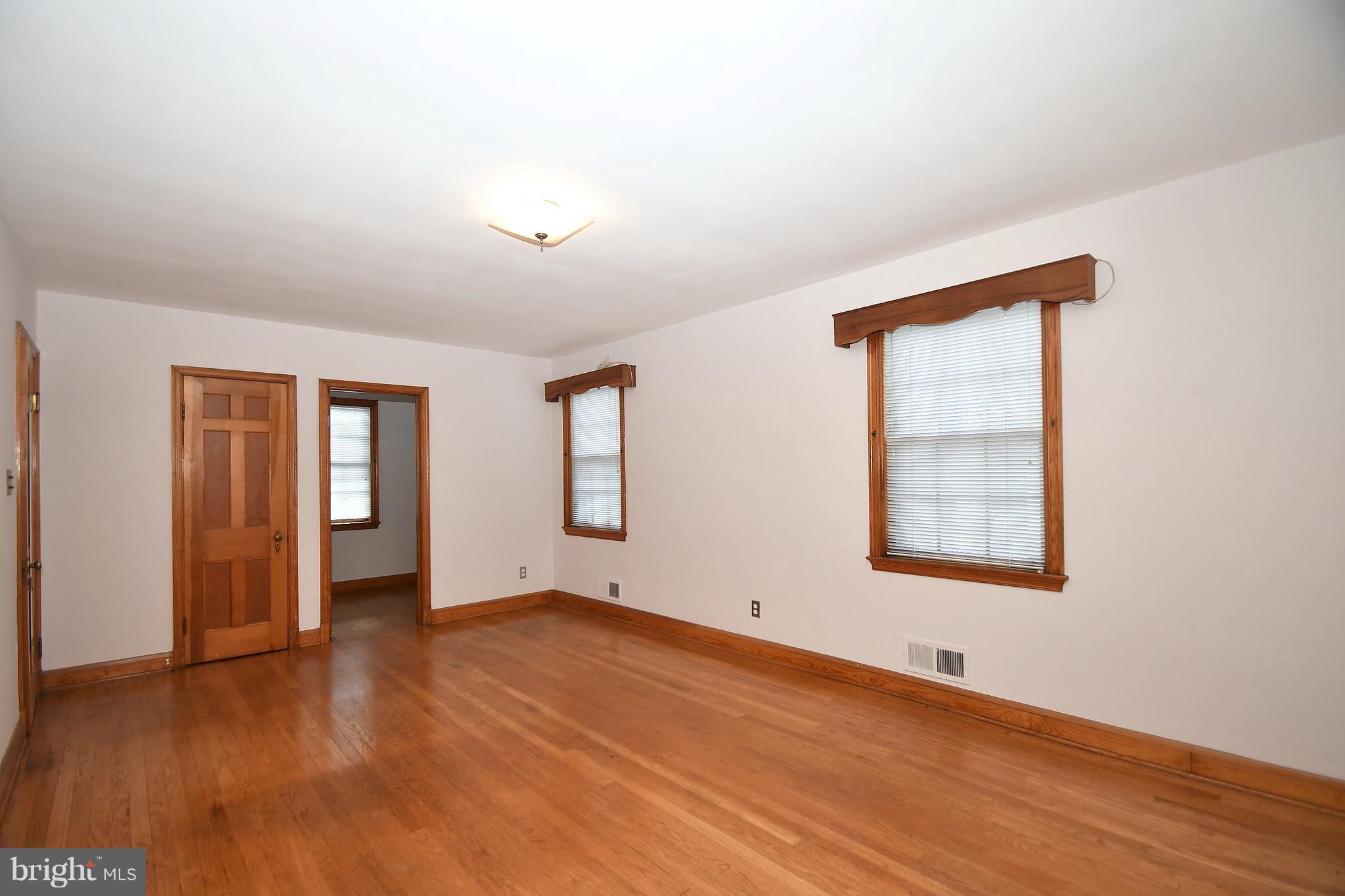 7009 Mornington Road Dundalk, MD 21222 - Photo 22 of 48 an empty room with wooden floor and windows