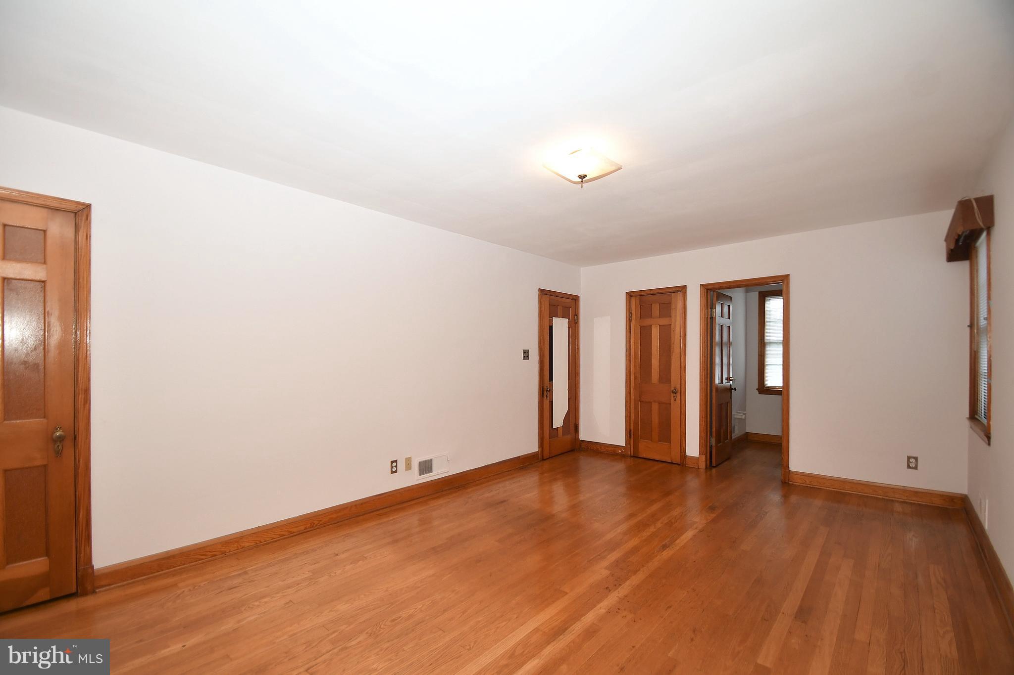 7009 Mornington Road Dundalk, MD 21222 - Photo 23 of 48 an empty room with wooden floor and natural light